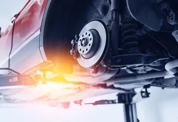 Vehicle brake disc and caliper system, where friction materials are produced with controlled curing and post-curing industrial ovens