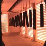 Infrared radiation curing oven in operation — parts hanging in curing chamber with infrared heaters