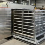 Trolley type curing oven with side view — customizable load racks for different part sizes