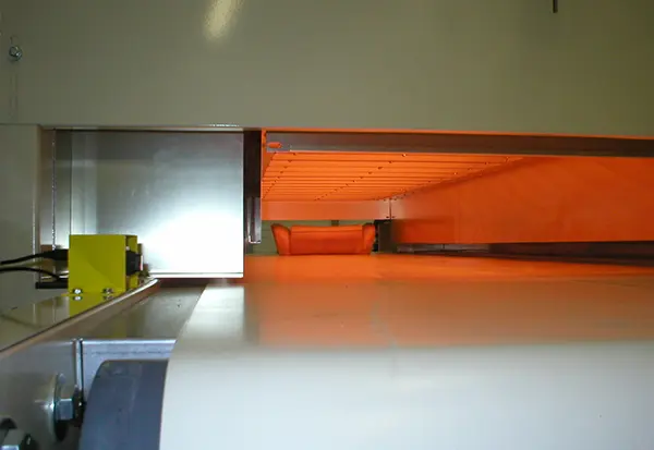 Infrared heating zone for rapid surface curing in a conveyor oven